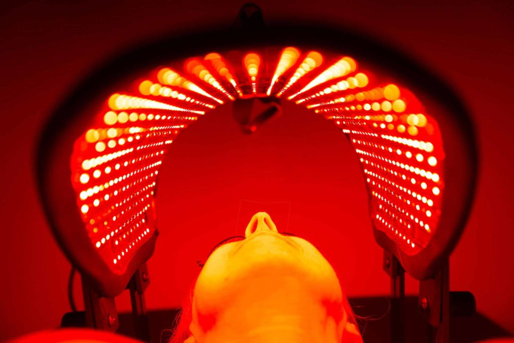 Overhead view of a patient beneath the Contour Light infrared hood