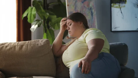 Seated woman over 40 looking worried or stressed